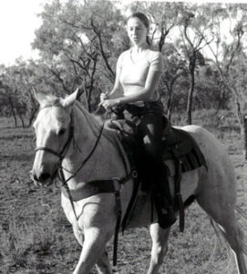 Isabella Leong riding a white horse.