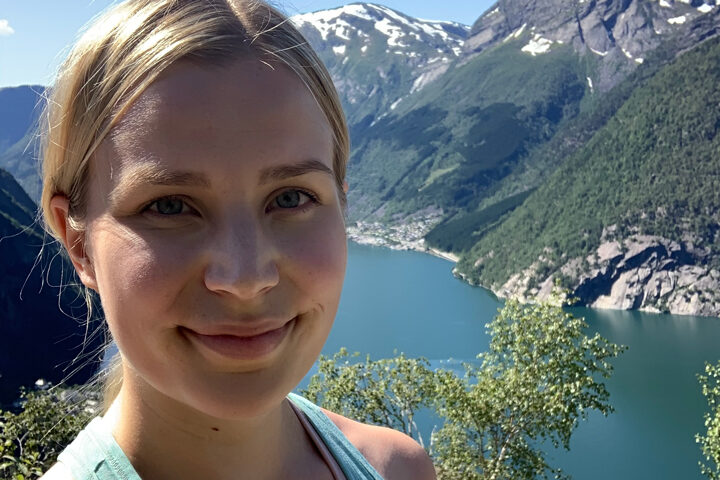 Tuuli Veikkanen close-up with beautiful mountainous landscape in the background.