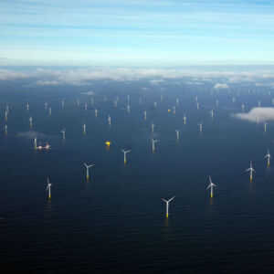 Inn2POWER is all about offshore wind energy, growing and innovating together. In the photo, you see a wind farm in the North Sea under a blue sky, however we also observe some clouds, symbolising the current situation of the offshore wind industry: The future looks bright, but there are challenges – definitely for SMEs – such as finding the right business partners abroad or available test and demonstration facilities. With the Inn2POWER project, we support the sector, SMEs in particular, in overcoming such bottlenecks. Offshore wind park in the North Sea with a boat, a yellow floating device and clouds
