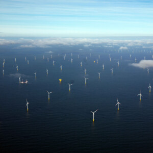 Inn2POWER is all about offshore wind energy, growing and innovating together. In the photo, you see a wind farm in the North Sea under a blue sky, however we also observe some clouds, symbolising the current situation of the offshore wind industry: The future looks bright, but there are challenges – definitely for SMEs – such as finding the right business partners abroad or available test and demonstration facilities. With the Inn2POWER project, we support the sector, SMEs in particular, in overcoming such bottlenecks. Offshore wind park in the North Sea with a boat, a yellow floating device and clouds