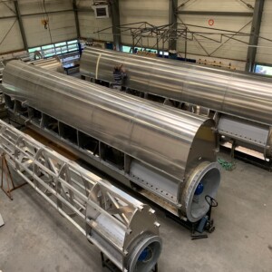 WASP: This photo shows three different processes of the development of the Wind Assisted Ship Propulsion technology, in this case a VentiFoil, in the fabric. This wind propulsion solution will be harvesting the North Sea abundant wind potential once installed on the ship of one of the five ship owners participating in the project. Wind assisted ship propulsion technology in process: Three large steel cylinders illustrate different stages of ventfoil development.