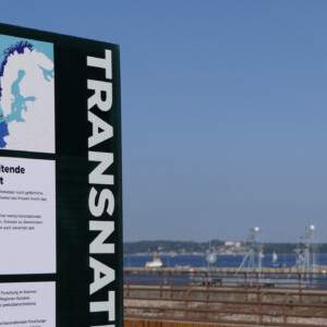 North Sea Wrecks: Detail of a billboard from the North Sea Wrecks exhibition "Toxic Legacies of War" showing the importance of transnational cooperation and the EU support. Photo: Cornelia Riml Billboard including the word "transnational" in large letters.