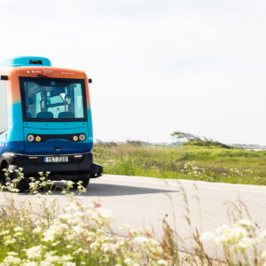 PAV: Future proofing autonomous mobility in cities across Europe. A blue and orange autonomous bus on the road